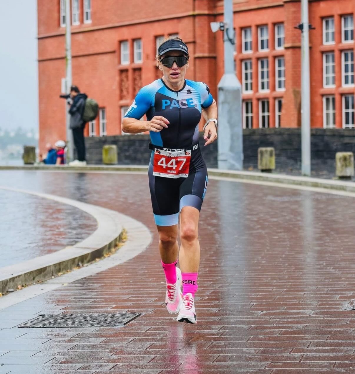 PACE athlete running on a wet city street