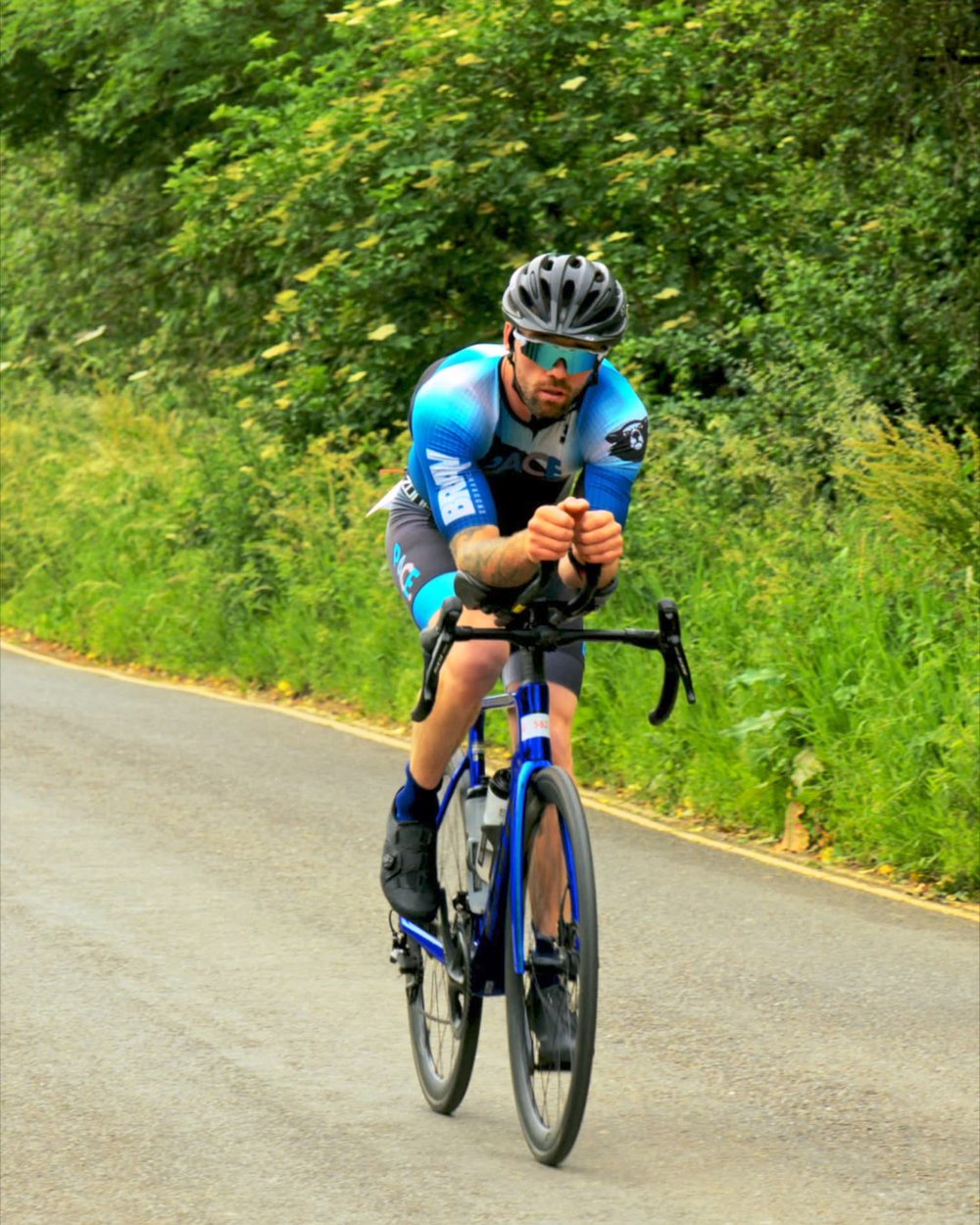 PACE athlete riding a time-trial bike in an aero position